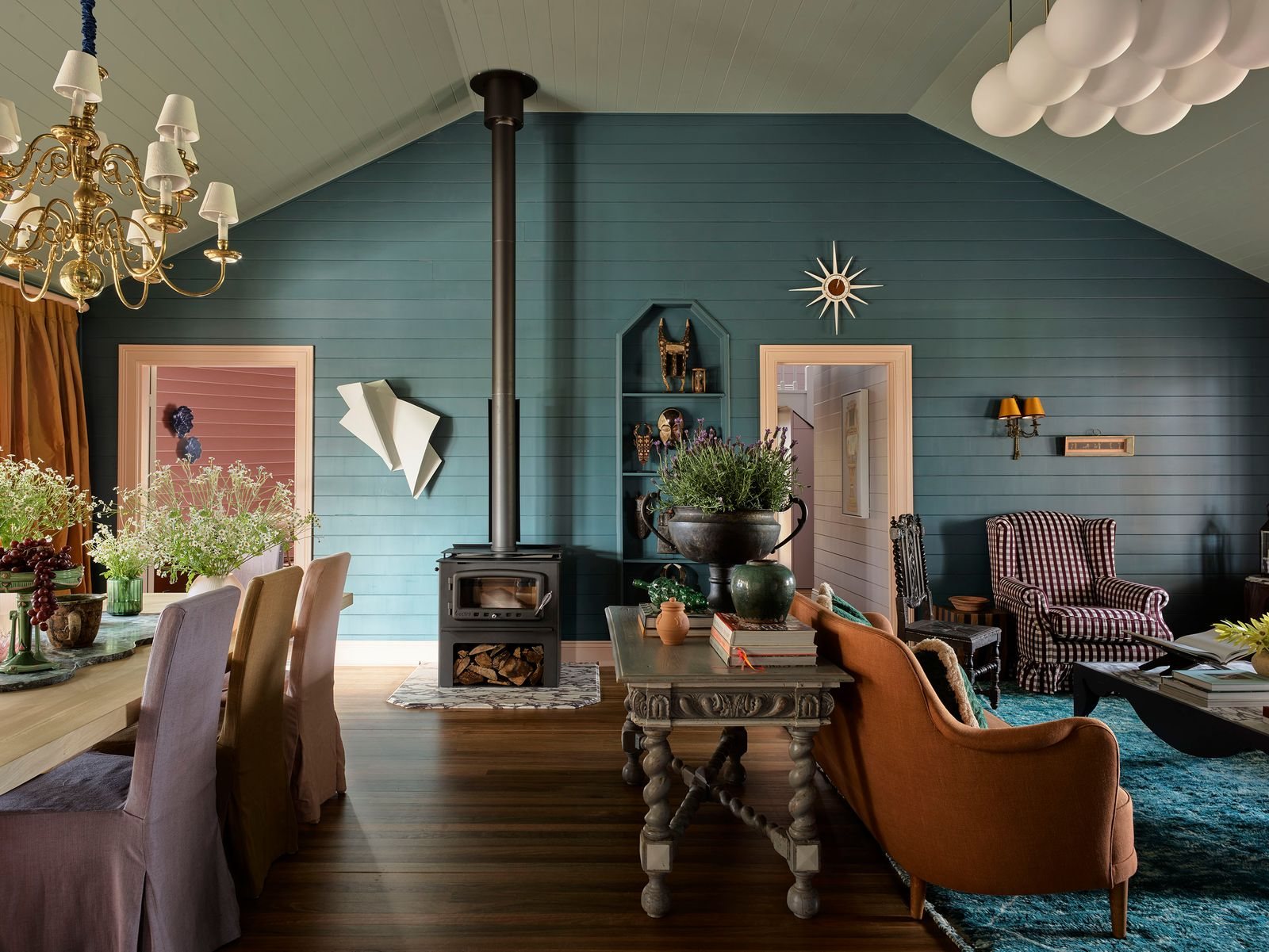 The Homestead dining room with a wood heater, blue walls and a long table
